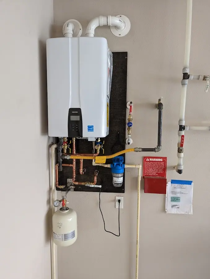 Professional plumber installing copper piping in a Harding home